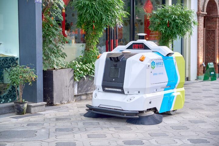 Autonomous street sweeper on a paved walkway