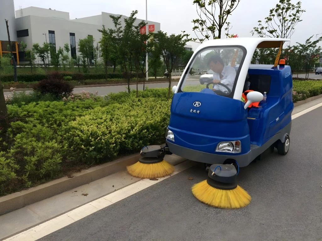 Compact electric sweeper cleaning along a roadside curb